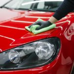 man polishing his car using a micro fiber towel 1