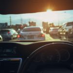 man driving on the road on a sunny day