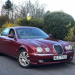 man parking his jaguar s type r