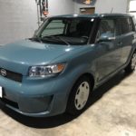 man parking his scion xb