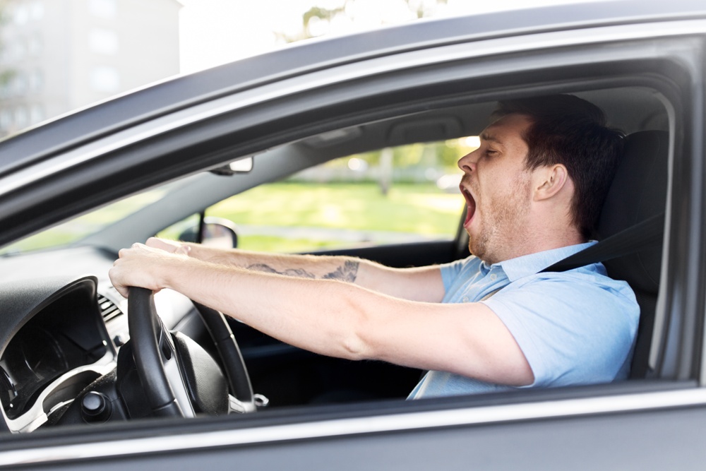 driver yawning and getting drowsy while driving