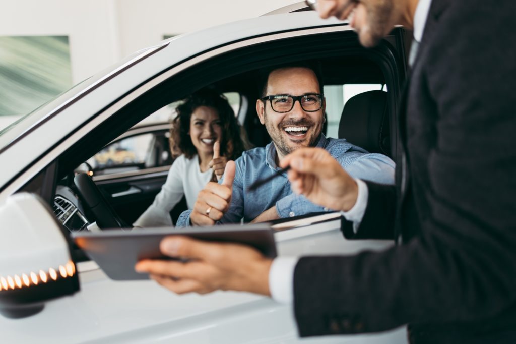 Customer getting a great deal on a new car from the dealership