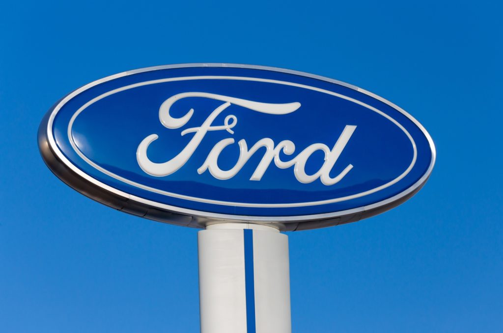 Ford dealership logo against blue sky