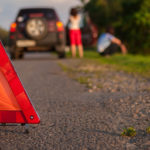 couple car trouble with triangular sign