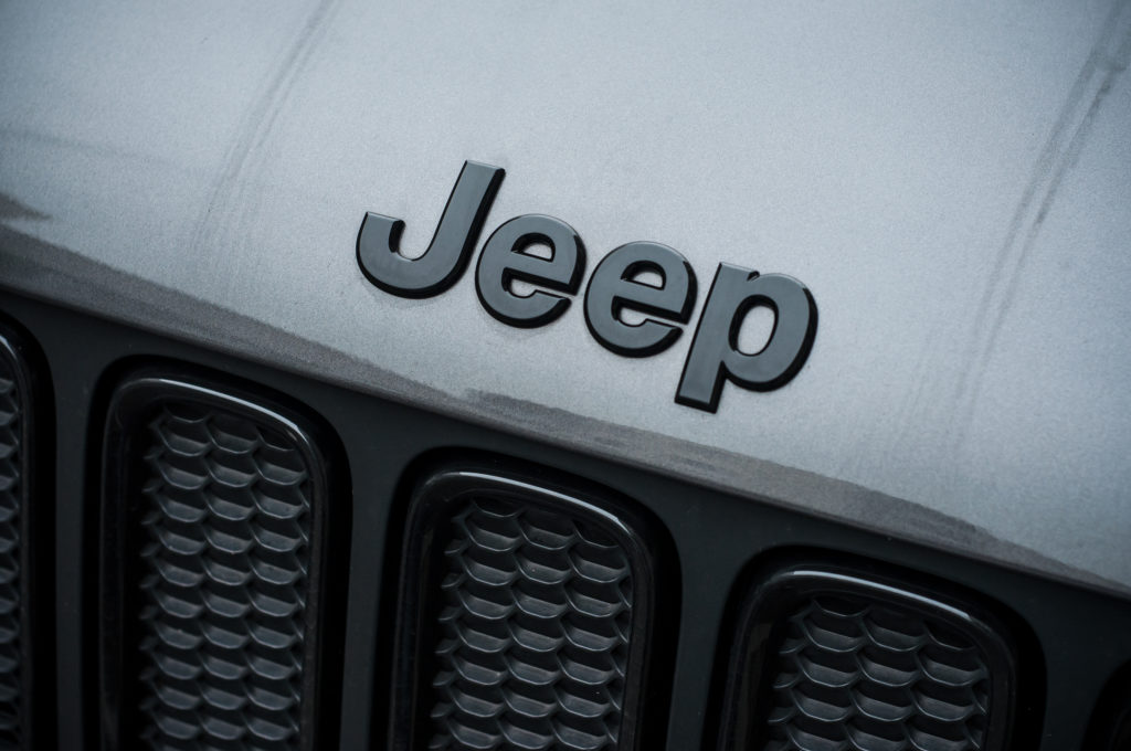 jeep logo on jeep parked outside scaled