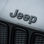 jeep logo on jeep parked outside scaled