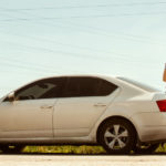 traveling couple sitting on a car