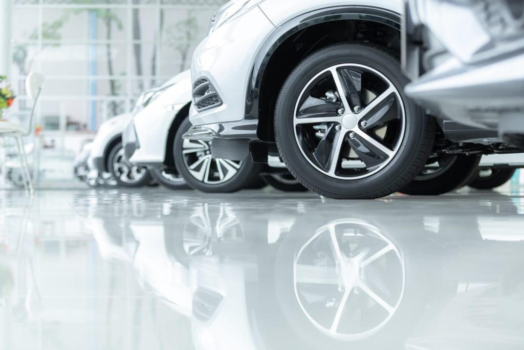 Cars for sale lined up in dealership parking lot