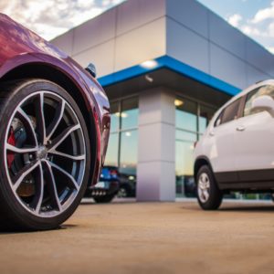 cars for sale parked outside dealership building