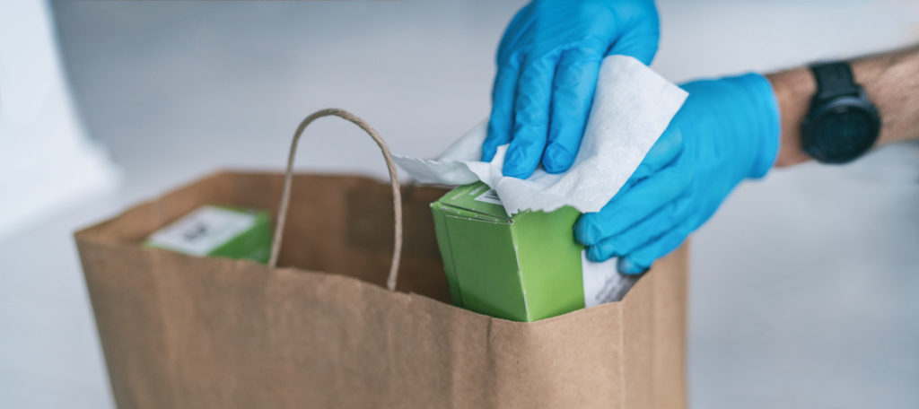 wiping grocery items in a bag using wipes