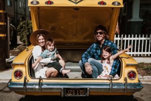 Lloyd and his family sitting in the trunk of California Love, his '61 Chevy Impala