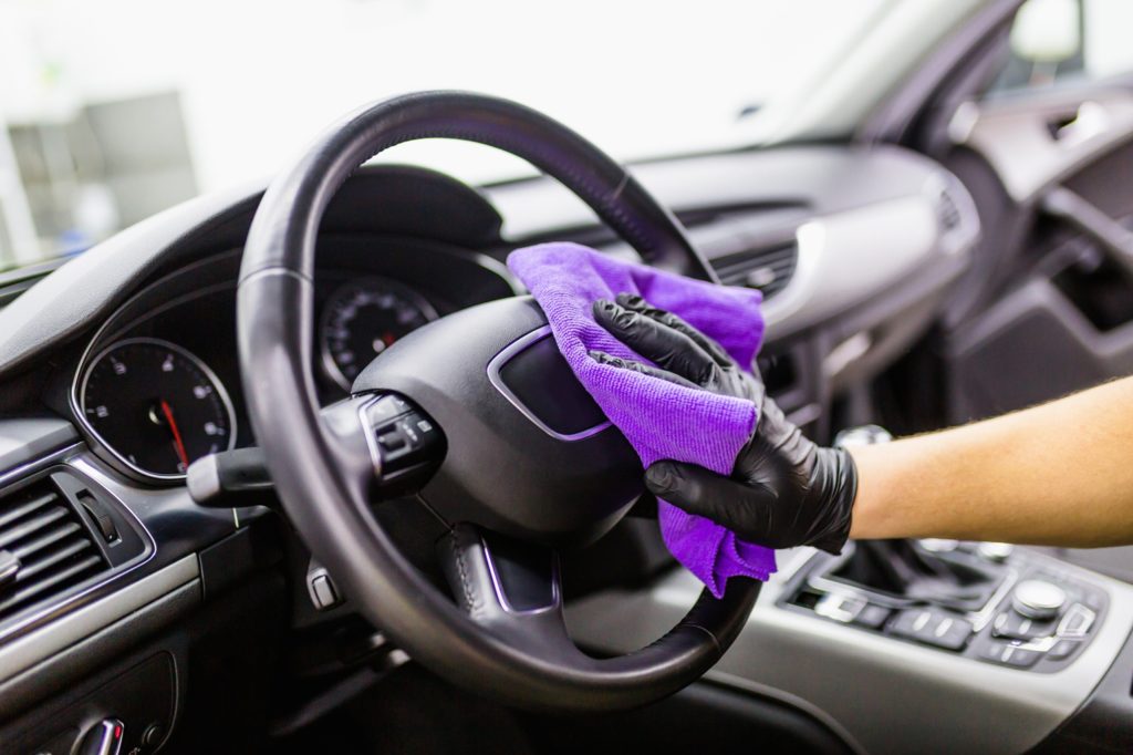 Man cleaning car interior