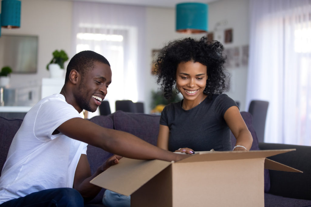 happy couple assembling a care package