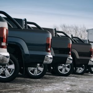 different pickup trucks lined up in parking lot