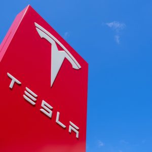 tesla building signage against blue sky