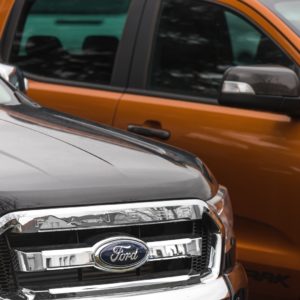 two ford trucks parked side by side