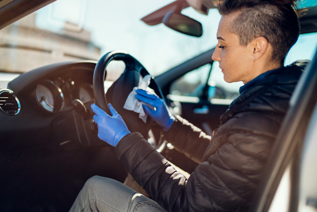 woman with short hair driving a car