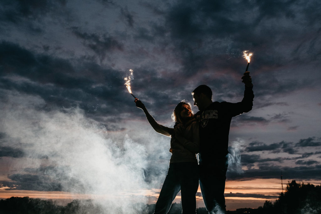 couple holding sparklers on fourth of july