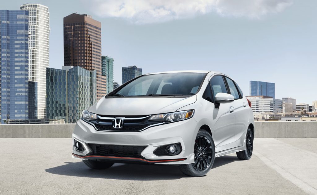 Honda Fit with buildings as backdrop