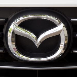 closeup of mazda logo on car grille