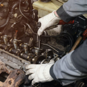 mechanic checking engine cylinder