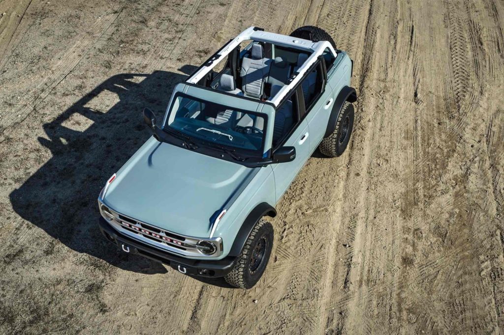 baby blue ford bronco on dusty road