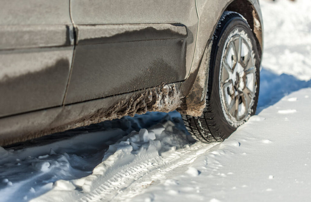 dirty car driving in the snow