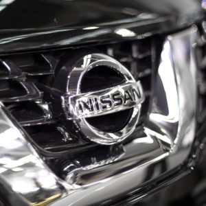 closeup of nissan chrome logo on truck grille