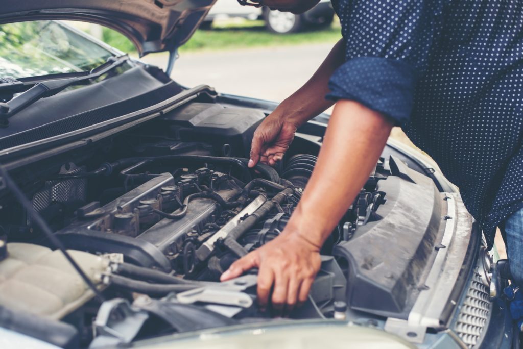 man checking why engine fails to idle