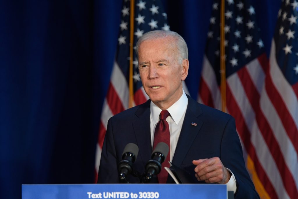 joe biden speaking behind a podium