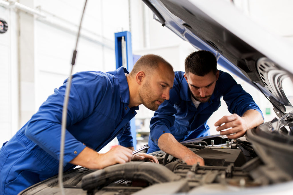 mechanic checking under the car's hood