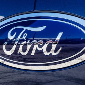 closeup of ford logo on blue truck