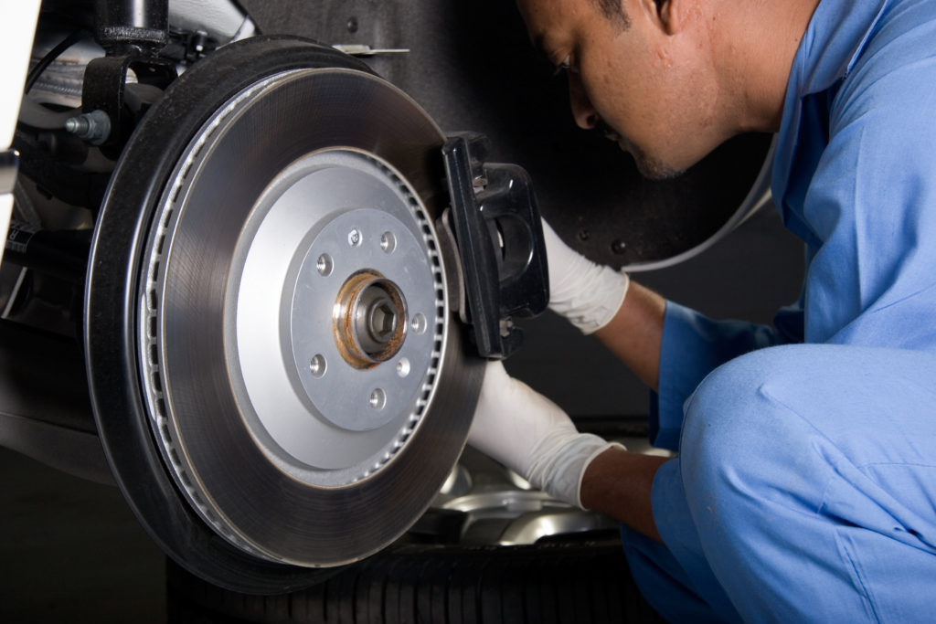 mechanic inspecting brakes