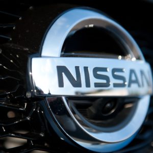 closeup of nissan logo on grille