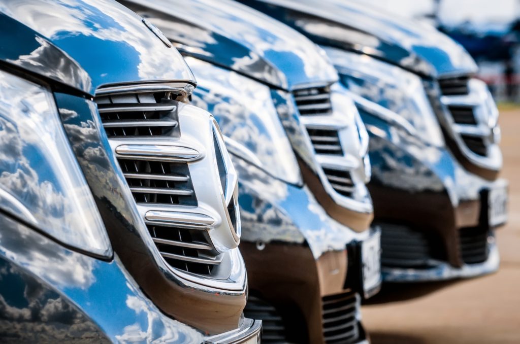 mercedes benz cars lined up in parking lot