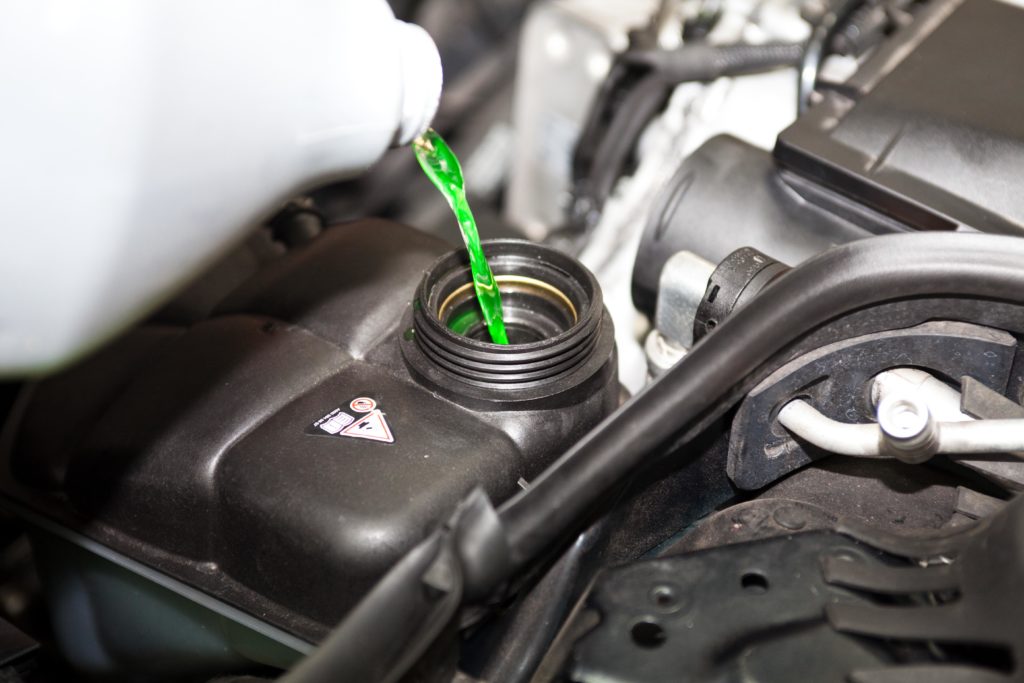 Pouring antifreeze into the car