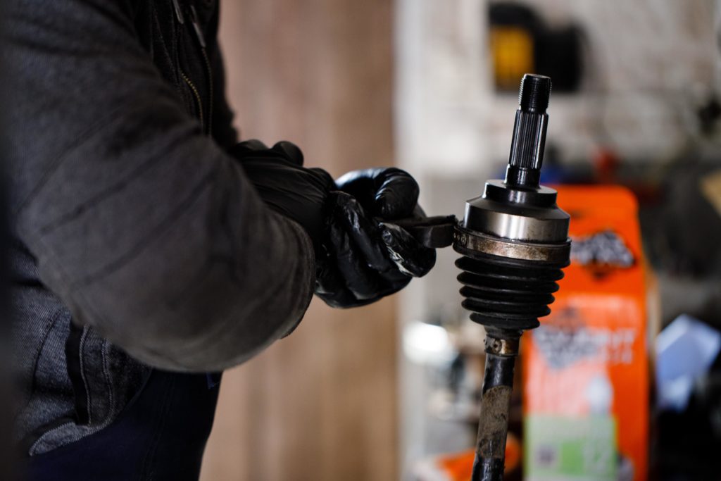 mechanic holding a cv axle