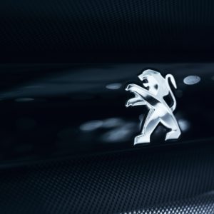 silver peugeot logo on black background