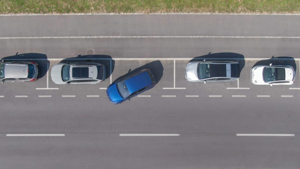 blue car trying to parallel park