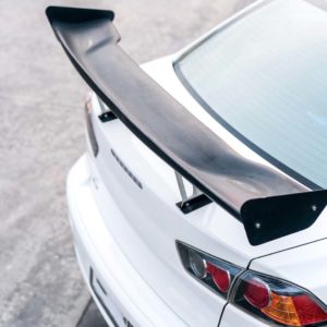 custom racing carbon fiber spoiler on white car close up