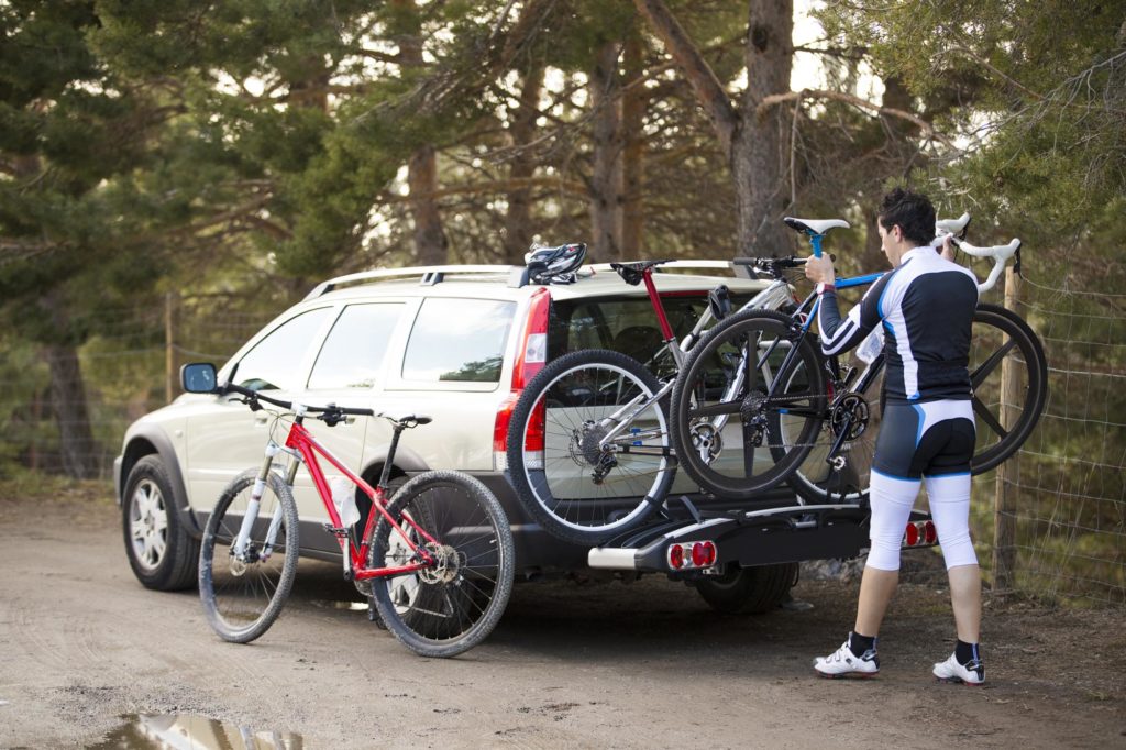 man loading bikes at the back of a van