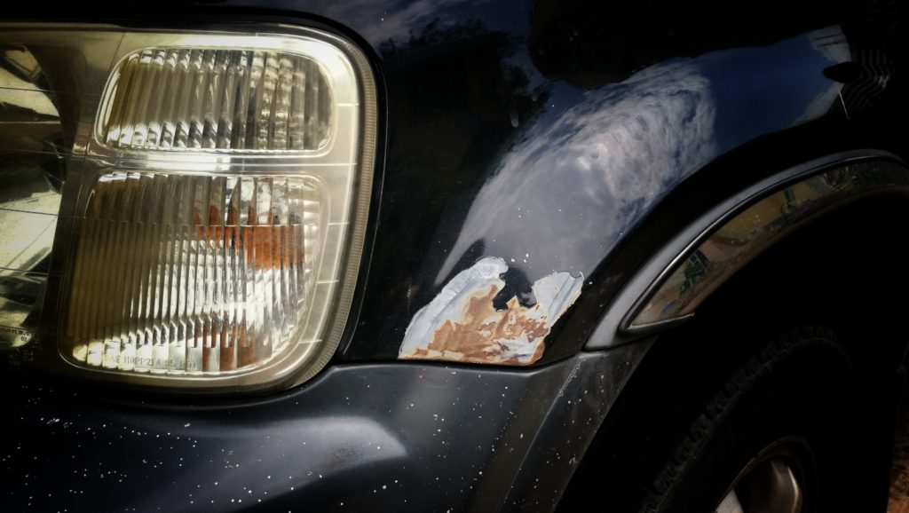 rust on a black vehicle bumper