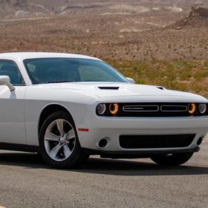 white dodge challenger travels on road