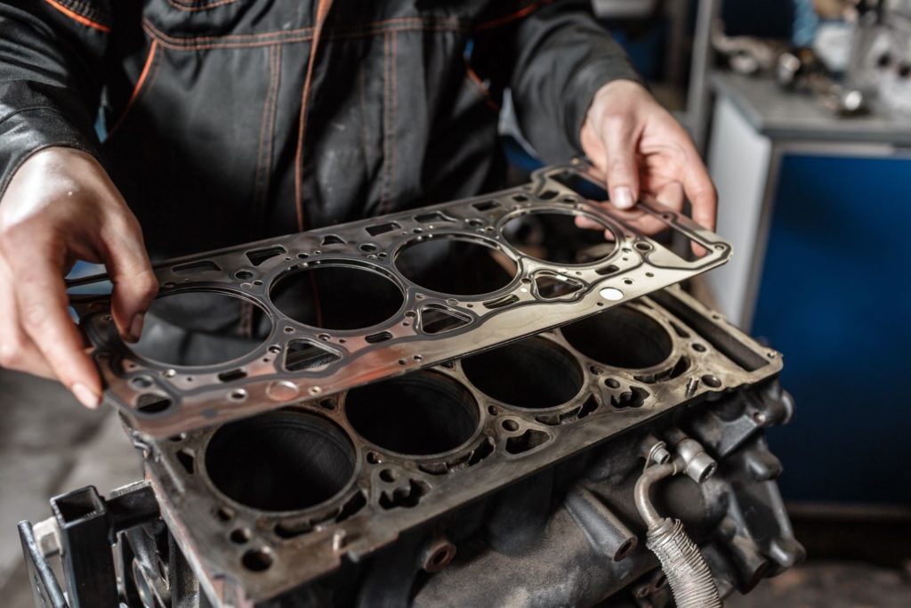 mechanic holding head gasket