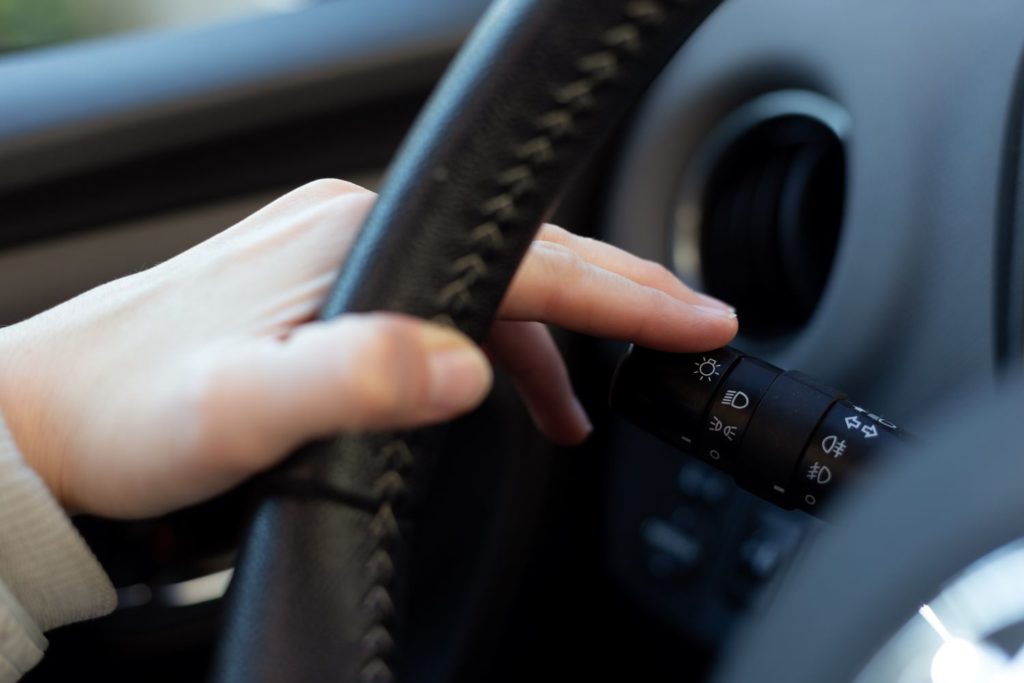 woman using turn signal switch