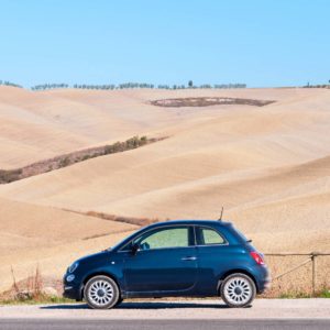 Fiat 500 parked with rural background