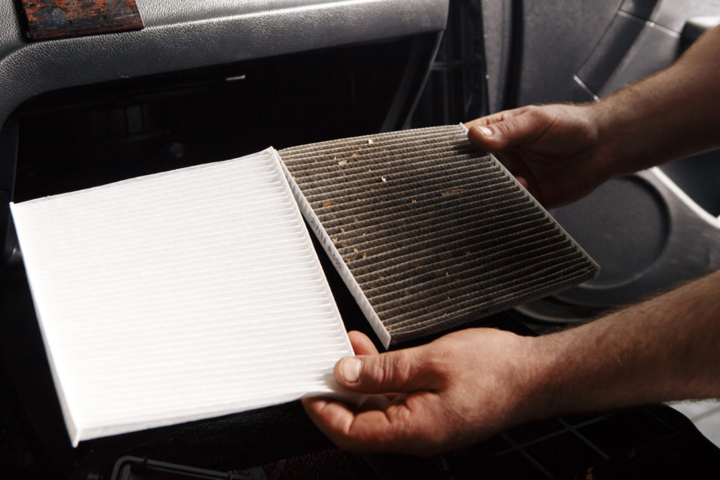 person replaces car air and cabin filters.jpg