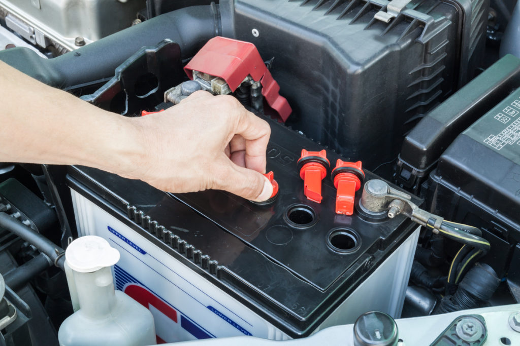 person replacing new car battery.jpg