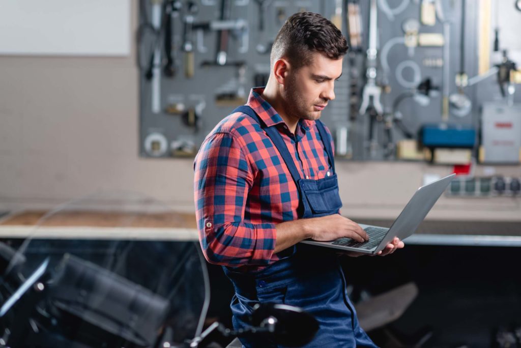 young man checks laptop for diagnostic guides