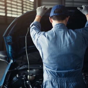 male mechanic engaged in automotive inspection after obd diagnosis